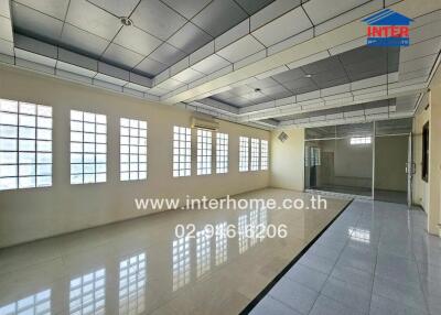 Spacious office with glass partitions and large windows