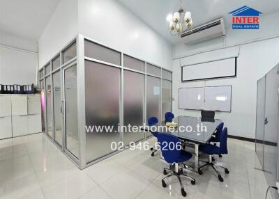 Modern office space with glass partitions and ergonomic chairs