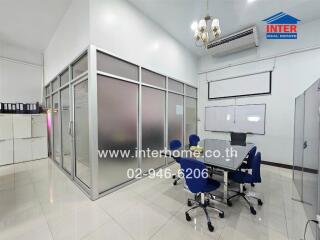 Modern office space with glass partitions and ergonomic chairs