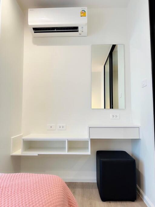 Dressing area with a mirror and air conditioner