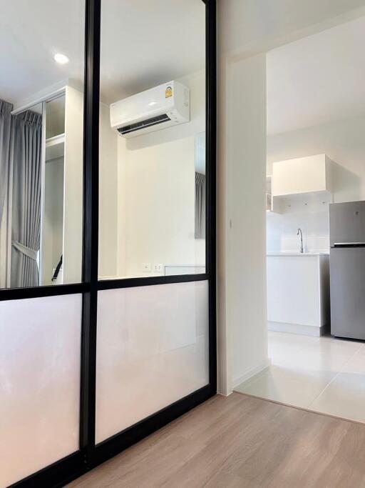 Modern kitchen and living area with glass partition