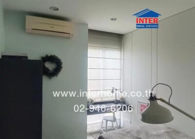 Bedroom with air conditioner and built-in wardrobe