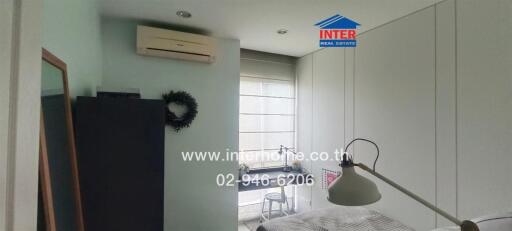 Bedroom with air conditioner and built-in wardrobe