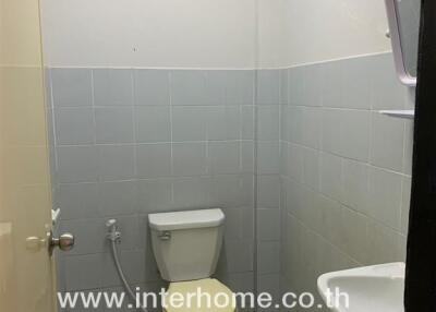 Small bathroom with toilet and wall-mounted sink