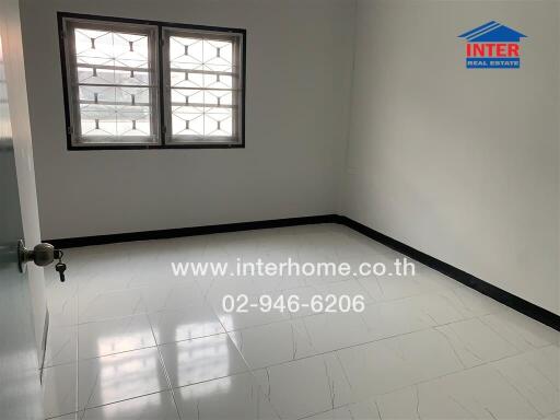 Bedroom with two windows and tiled floor