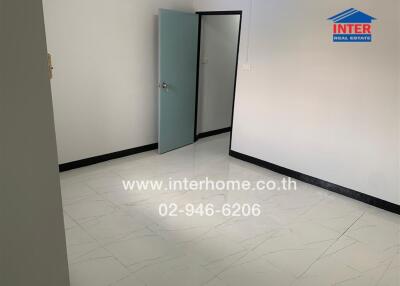 Empty bedroom with tiled floor and open door