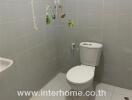 Small clean bathroom with grey tiles and wall art