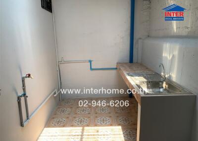 Simple kitchen with tiled countertop and sink