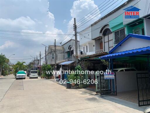 Street view of residential area with houses and driveways