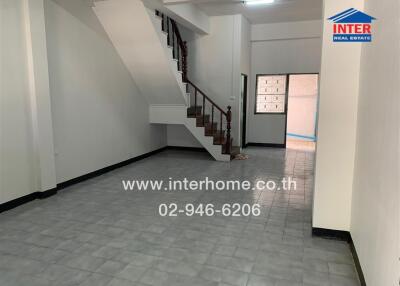 Spacious main living area with staircase in a property listed for sale