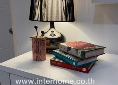 Nightstand with lamp and books