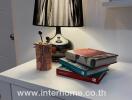 Nightstand with lamp and books