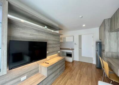 Modern living room with wooden flooring and built-in entertainment center