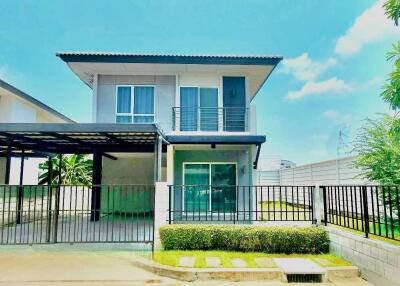 Modern two-story house with driveway and garden