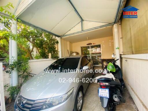 Garage with vehicle and motorbike, covered roof, and concrete floor