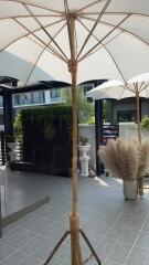 Modern outdoor patio with umbrellas and potted plants
