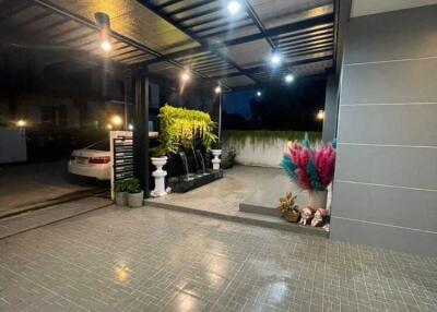Covered carport with plants and lighting