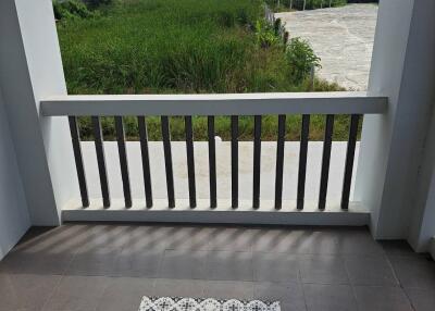 Balcony with tiled flooring and a railing view.