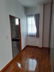 Small bedroom with wooden floor and window