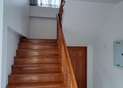 Wooden staircase with railing and door