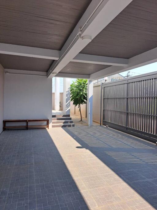 Covered outdoor area with steps leading to a courtyard