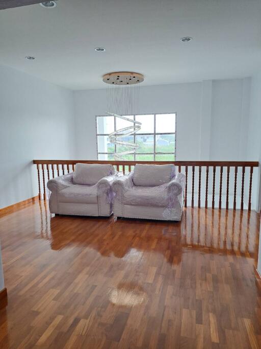 Bright living room with large windows and two armchairs