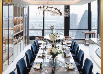 Elegant dining room with a large table set for a meal, featuring modern decor and a city view
