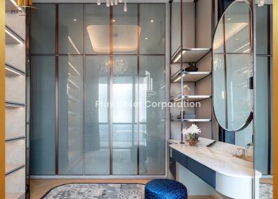 Modern bedroom with glass wardrobes and a chandelier