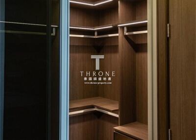 Walk-in closet with wooden shelves and LED lighting
