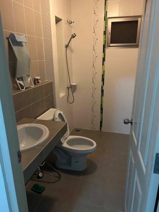 Bathroom with shower, sink, and toilet