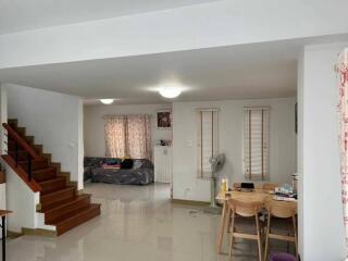 Modern living area with stairs and dining table