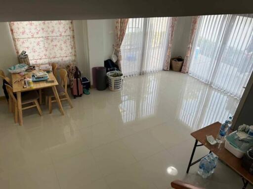 Spacious living room with dining area and large windows