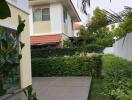 Modern residential building with a garden and tiled pathway