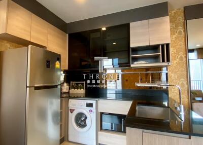 Modern kitchen with stainless steel appliances and washing machine