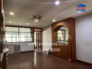 Spacious living room with wooden flooring and built-in shelves