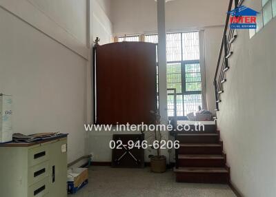Entrance or lobby area with stairs and a filing cabinet