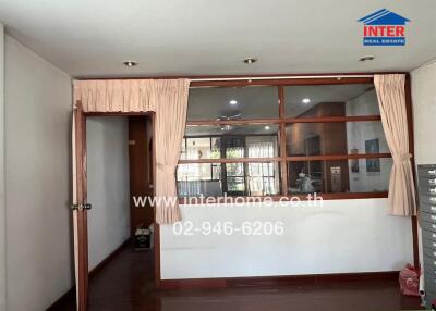 Living area with interior window and wooden floor