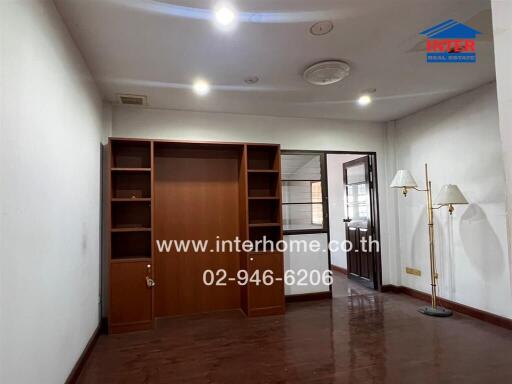 Modern living room with wooden shelving and floor lamps