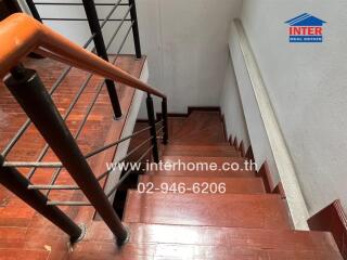 wooden staircase with metal railing