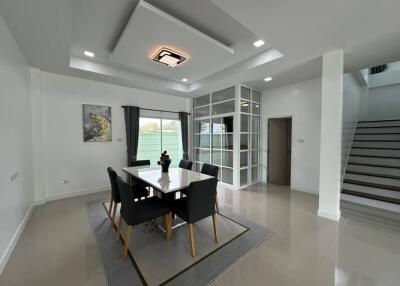 Modern dining area with table, chairs, and decorative ceiling