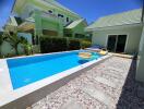 Backyard with a swimming pool and adjacent buildings