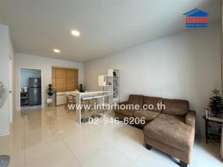 Modern living room with brown sofa and dining area