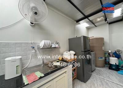 Kitchen area with essential appliances and sink