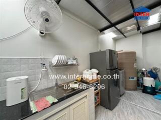 Kitchen area with essential appliances and sink