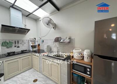 Modern kitchen with stainless steel appliances and a skylight