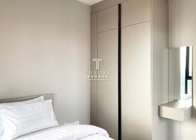 Modern bedroom with a large wardrobe and a mirror