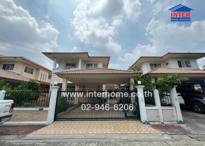 Front view of a residential house with gated entrance