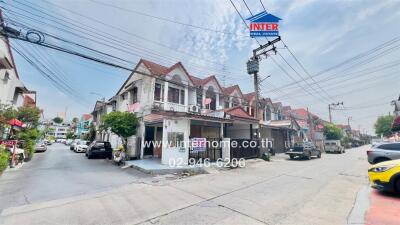 Street view of a row of houses and an office building