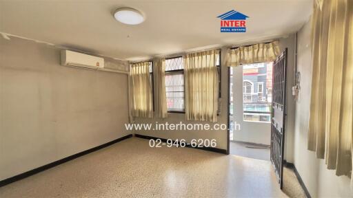 Living room with windows, curtains, and air conditioner