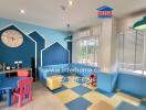 Bright and colorful children's playroom with blue walls, colorful furniture, and toys.